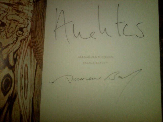 A copy of the show's catalog signed by Costume Institute curator Andrew Bolton as well as Vogue editor Anna Wintour